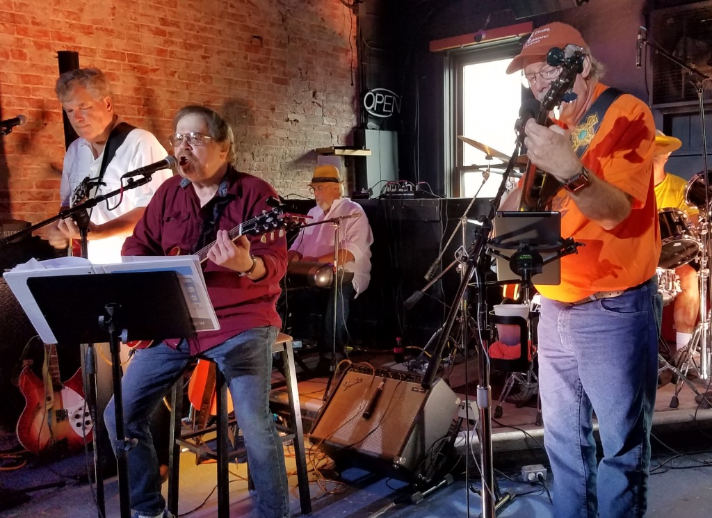 Its the Missing Links! L to R: Doug Pope (67, white shirt), Ken Reeves (68, seated), Brad Mansfield (67,  background), John Ziegler (67, orange shirt), Jim Ziegler (on drums, sitting in for original drummer Dan Householder 67, who was not able to attend).